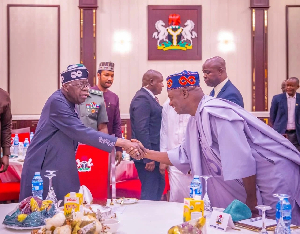 President Bola Tinubu in a handshake with the APC National Chairman Nentawe Yilwatda
