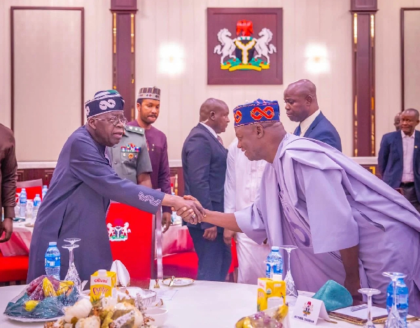 President Bola Tinubu in a handshake with the APC National Chairman Nentawe Yilwatda