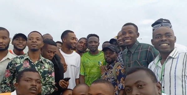 Ahmed Musa with workers at the Godswill Akpabio Stadium