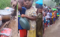 Children waiting for food in rain