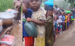 Children waiting for food in rain