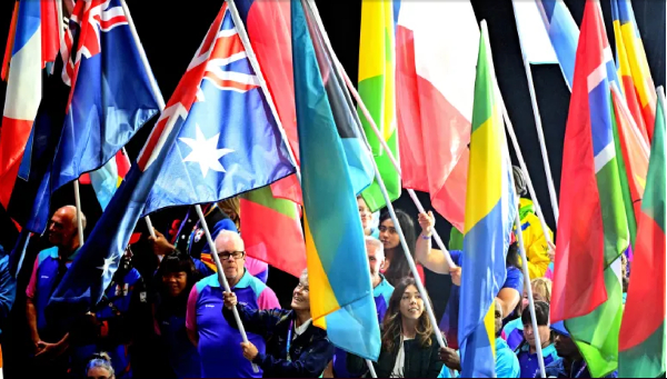 Athletes carry their country flags during the Closing Ceremony of Glasgow 2026 Commonwealth Games