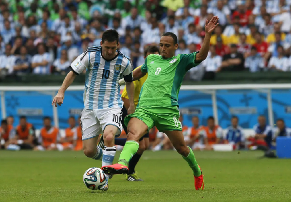 Lionel Messi and Peter Odemwingie during the 2014 FIFA World Cup