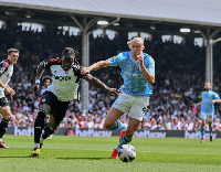 Erling Haaland holds off the challenge from Fulham's Calvin Bassey
