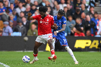 Ola Aina of Nottingham Forest shields the ball from Noni Madueke