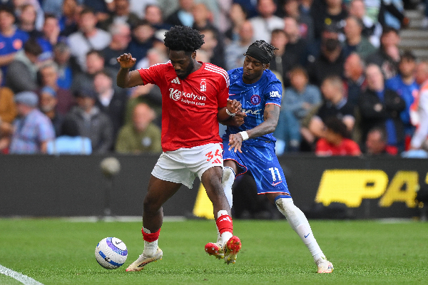 Ola Aina of Nottingham Forest shields the ball from Noni Madueke