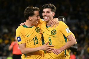 Australia'ss Jordan Bos (R) celebrates with teammate Riley McGree after scoring a goal