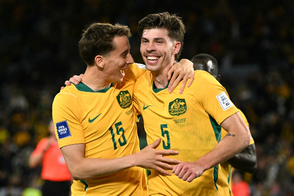 Australia'ss Jordan Bos (R) celebrates with teammate Riley McGree after scoring a goal