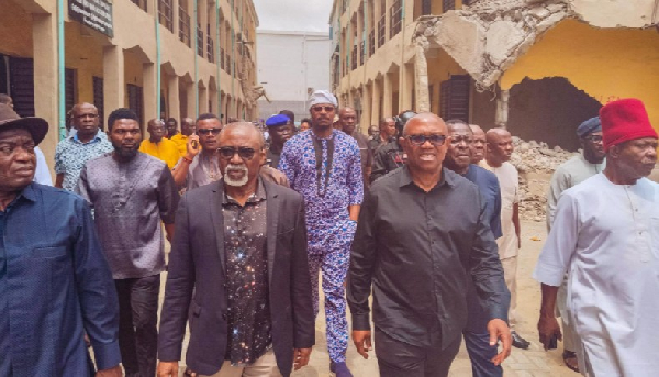 Obi and others at the scene of the demolition