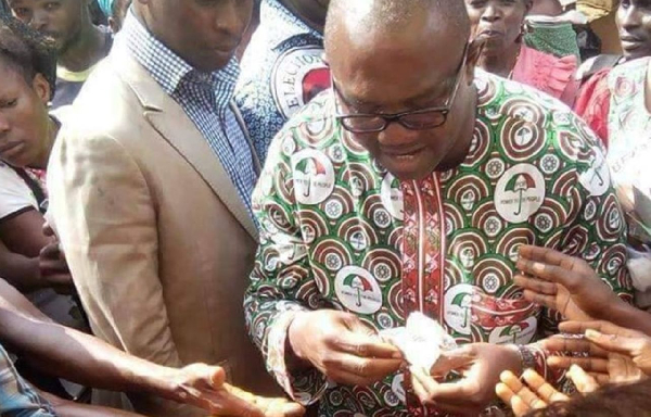 Peter Obi sharing money to people