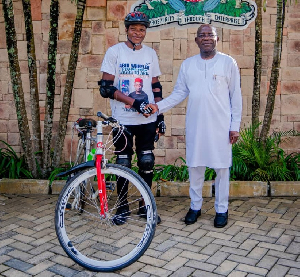 Cyclist, Wisdom Chisom and Abia State Governor, Alex Otti Cyclist, Wisdom Chisom and Abia State Governor, Alex Otti
