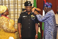 President Bola Tinubu decorates acting Inspector-General of Police, Tunji Disu