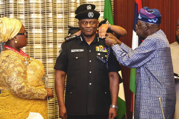 President Bola Tinubu decorates acting Inspector-General of Police, Tunji Disu