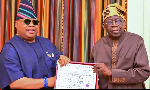 Osun State Governor, Ademola Adeleke, presenting his return certificate to President Bola Tinubu