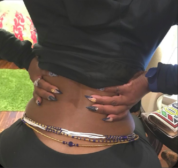 A Nigerian woman wearing waist beads