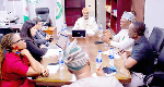 Adeniyi Adeyemi (m) presiding over a meeting in his office
