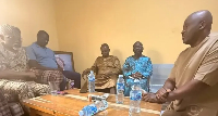 Desmond Elliot kneeling before Gbajabiamila